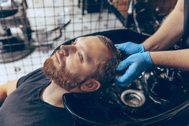 close-up-man-getting-hair-cut-barbershop-wearing-mask-during-coronavirus-pandemic